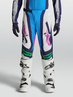 Calças Alpinestars Supertech Maven Juventude, brancas e azuis com detalhes verde fluorescente e ajuste atlético.