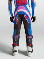 Alpinestars Supertech Maven, calças de motocross para juventude, azuis e rosa coral, com assento reforçado e ajuste atlético.