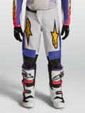 Alpinestars calças Fluid Drag Juventude, calças de motocross brancas e azuis, gráficos dourados e ajuste para todo-o-terreno.