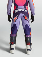 Alpinestars Fluid Hunt Juventude, calças de motocross para jovens, roxas e rosa, vista traseira com logótipos Astars e construção em politecido durável.