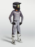 Calças Alpinestars Fluid Amber Juventude, areia e branco, ajuste desportivo para motocross com grafismos de estrela.