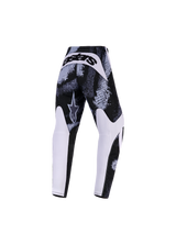 Alpinestars 2026 Youth Fluid Lahnd Pants, calças de motocross, Iron Camo, vista traseira com padrão abstrato em preto e branco, painéis brancos no interior das pernas e a marca 'astars' em destaque na pala traseira, equipamento de off-road durável para jovens pilotos