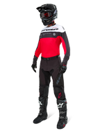 Alpinestars Pro-Dura Jersey, Motocross and Enduro Jersey, Black Bright Red and White, worn with black pants, black helmet, and black and white boots, featuring bold chest branding and laser perforations, high-performance gear for off-road riding