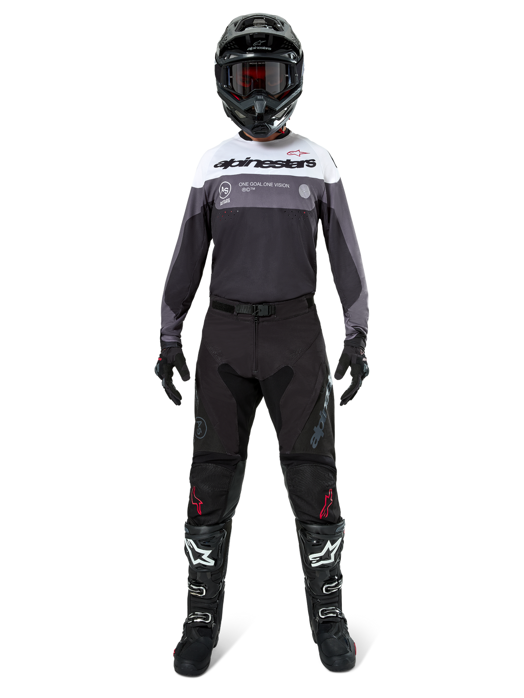 Piloto de motocross com equipamento completo, Camisola Pro-Dura em Black Magnet White com a parte superior do peito branca e detalhes cinzentos, calças pretas, capacete preto com óculos escuros, botas brancas e pretas e luvas pretas, conjunto coordenado para enduro e off-road