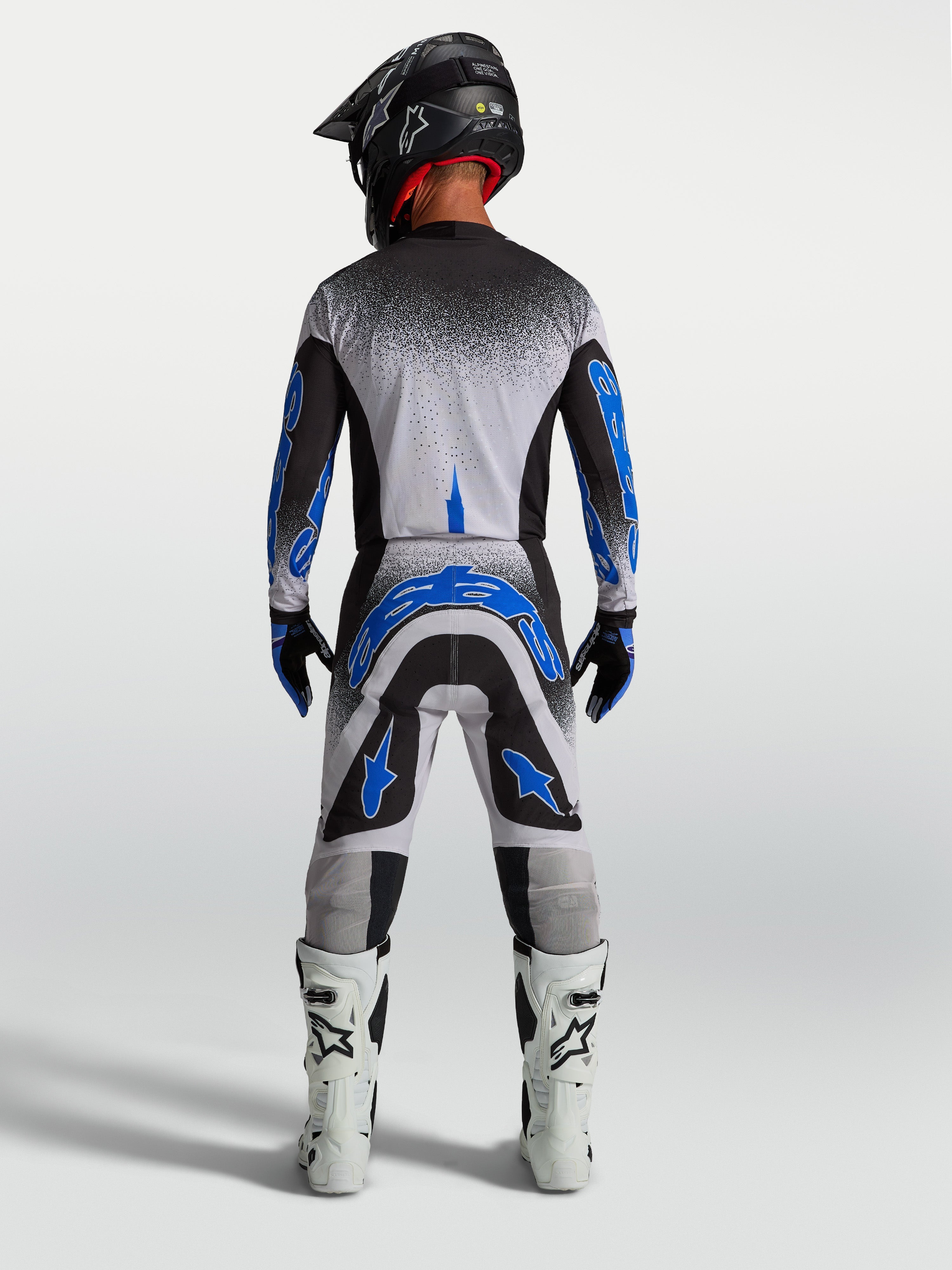 Alpinestars Supertech Hiten AFD, conjunto de motocross para homem em preto, branco e azul, vista traseira.