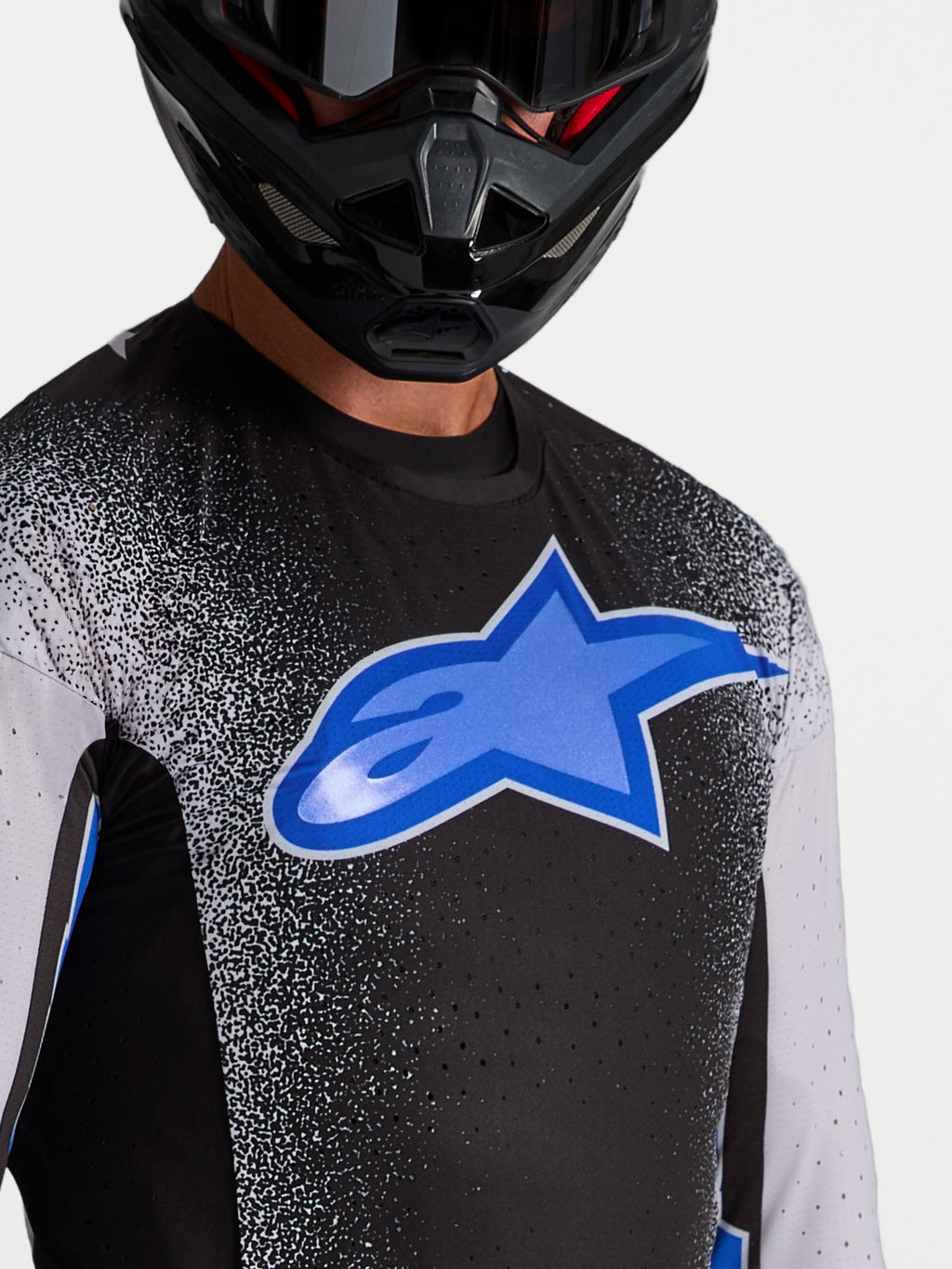 Alpinestars Supertech Hiten AFD, camisola de motocross para homem, preta e azul, com aberturas de ventilação cortadas a laser.