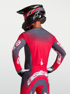 Alpinestars Camisola Supertech Hiten AFD, camisola de motocross em cinzento e vermelho fluorescente, com ventilação Stretchnet e ajuste atlético profissional.