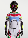 Alpinestars Supertech Dyna, camisola de motocross em lilás claro e verde fluorescente, malha elástica ventilada.