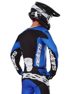 Alpinestars 2025 Racer Veil Gear Set, Motocross Gear, Blue Black and White, rear view of rider wearing jersey and pants with bold branding, black and white helmet, coordinated outfit for off-road racing