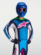 Alpinestars Camisola Techstar Maven, camisola de motocross para homem, azul e branca com logótipo rosa e gola verde fluo, design elástico e ventilado para corrida off-road.