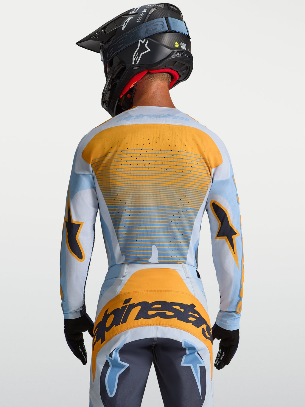 Camisola Alpinestars Techstar Maven, equipamento de motocross para homem, azul e laranja, vista traseira com ventilação a laser.