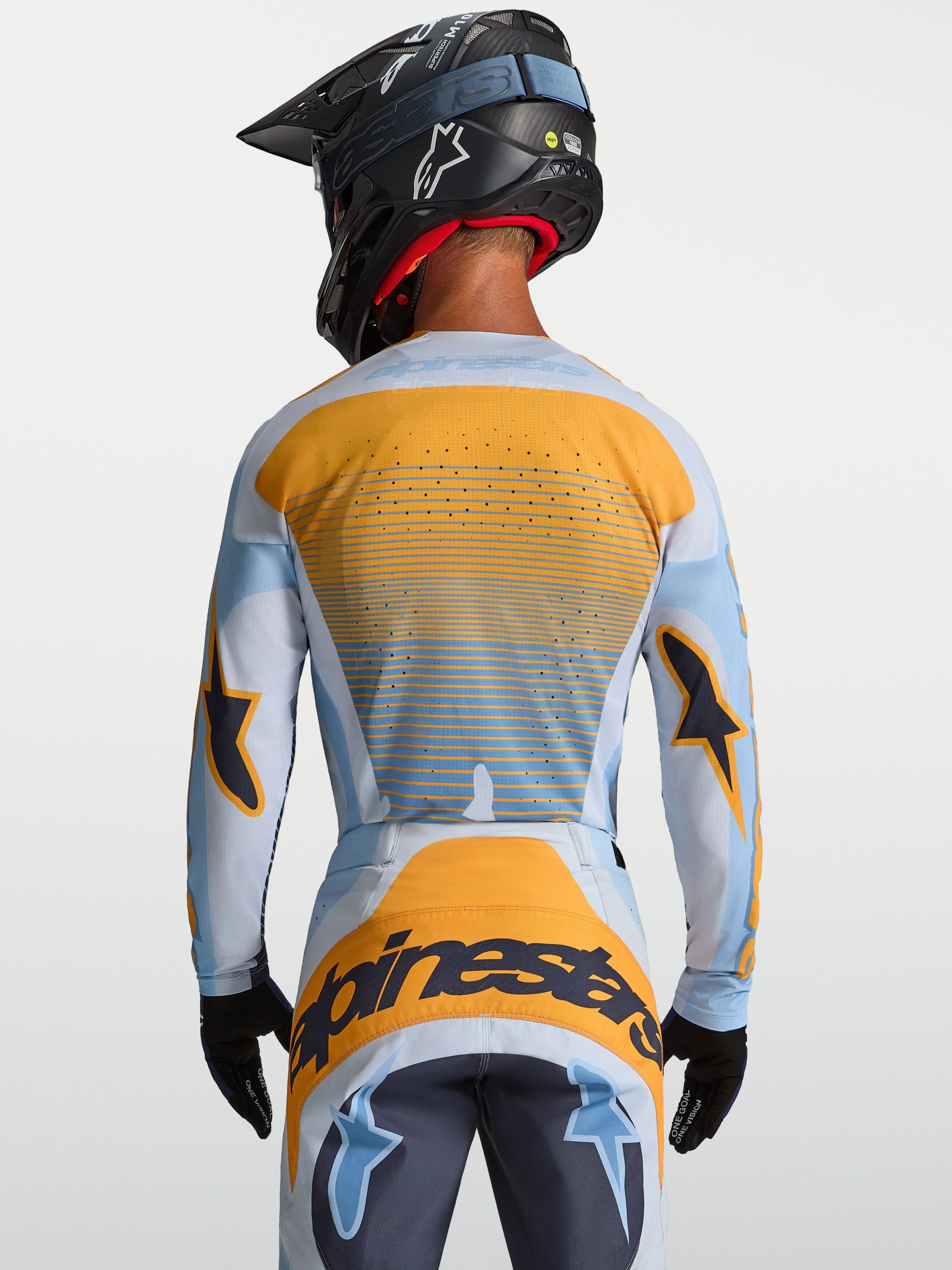Camisola Alpinestars Techstar Maven, equipamento de motocross para homem, azul e laranja, vista traseira com ventilação a laser.