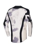 Alpinestars 2026 Racer Lahnd Jersey, camisola de motocross, camuflado areia com padrões de pinceladas em off-white e cinzento, vista traseira com painéis verticais em malha preta, gola preta e perfil traseiro alongado para maior cobertura.