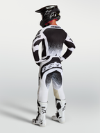 Alpinestars Camisola Techstar Swan e Techstar Swan Gear Set, equipamento de motocross para homem, preto e branco com gráficos de salpicos, vista traseira.