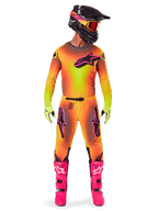 Motocross rider wearing complete racing gear, 2025 Supertech Lipan Jersey and Pants in a yellow and orange gradient with pink accents, black helmet with matching pink graphics, bright pink boots, and lime green gloves, coordinated Alpinestars off-road racing outfit.
