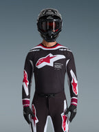 Alpinestars 2026 Supertech AFD Vista Gear Set, Motocross Gear Set, black jersey with red and white logos and 'Supertech AFD' branding, matching black pants with red accents, black helmet with red goggles, coordinated professional racing outfit