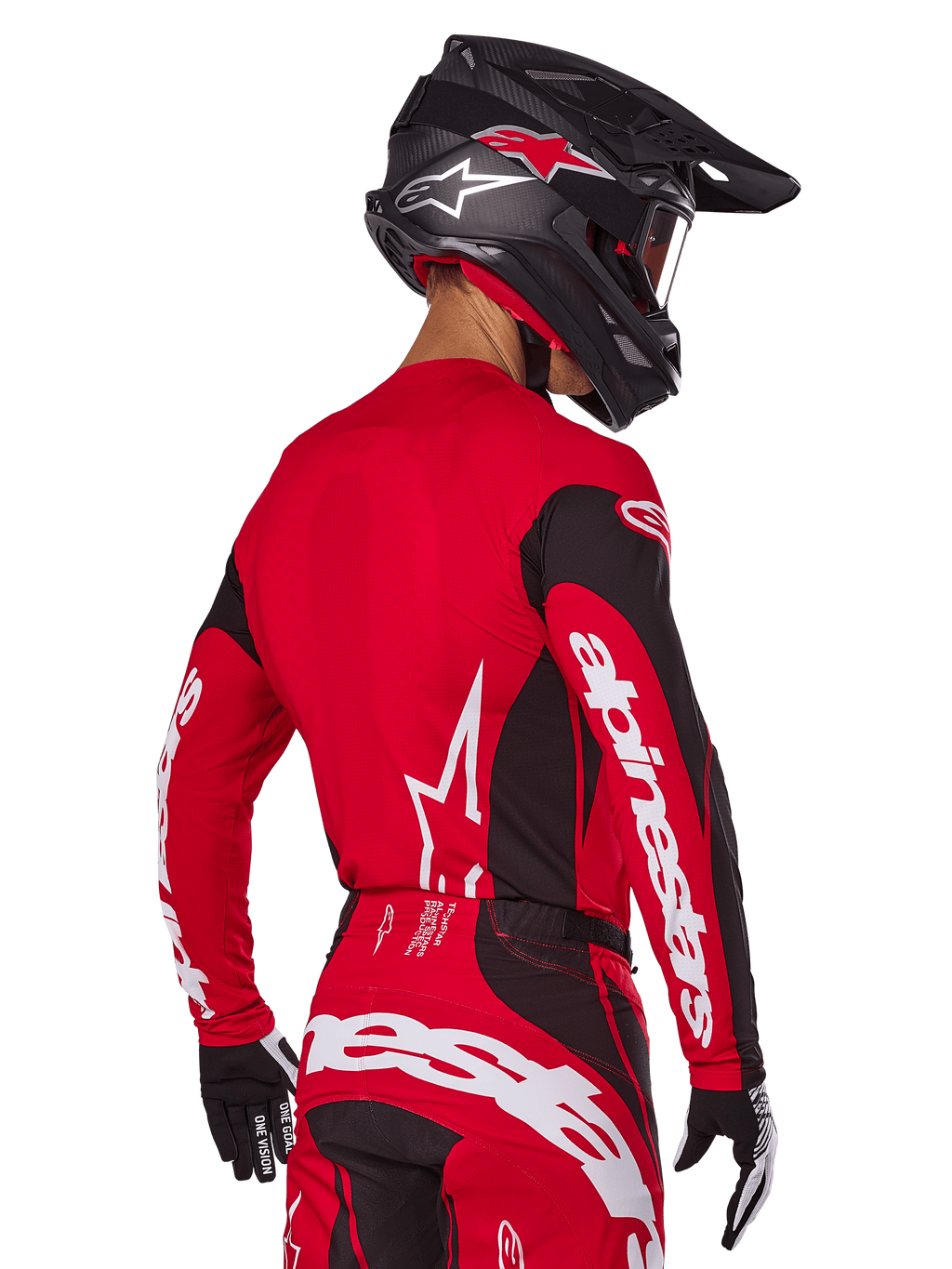 Piloto de motocross visto de costas a usar o conjunto de equipamento Alpinestars 2025 Techstar Dreem, camisola vermelha e preta com logótipo branco nas mangas, calças vermelhas e pretas condizentes com logótipo branco no assento, capacete de carbono preto com detalhes vermelhos, luvas pretas e brancas, equipamento de corrida profissional para todo-o-terreno