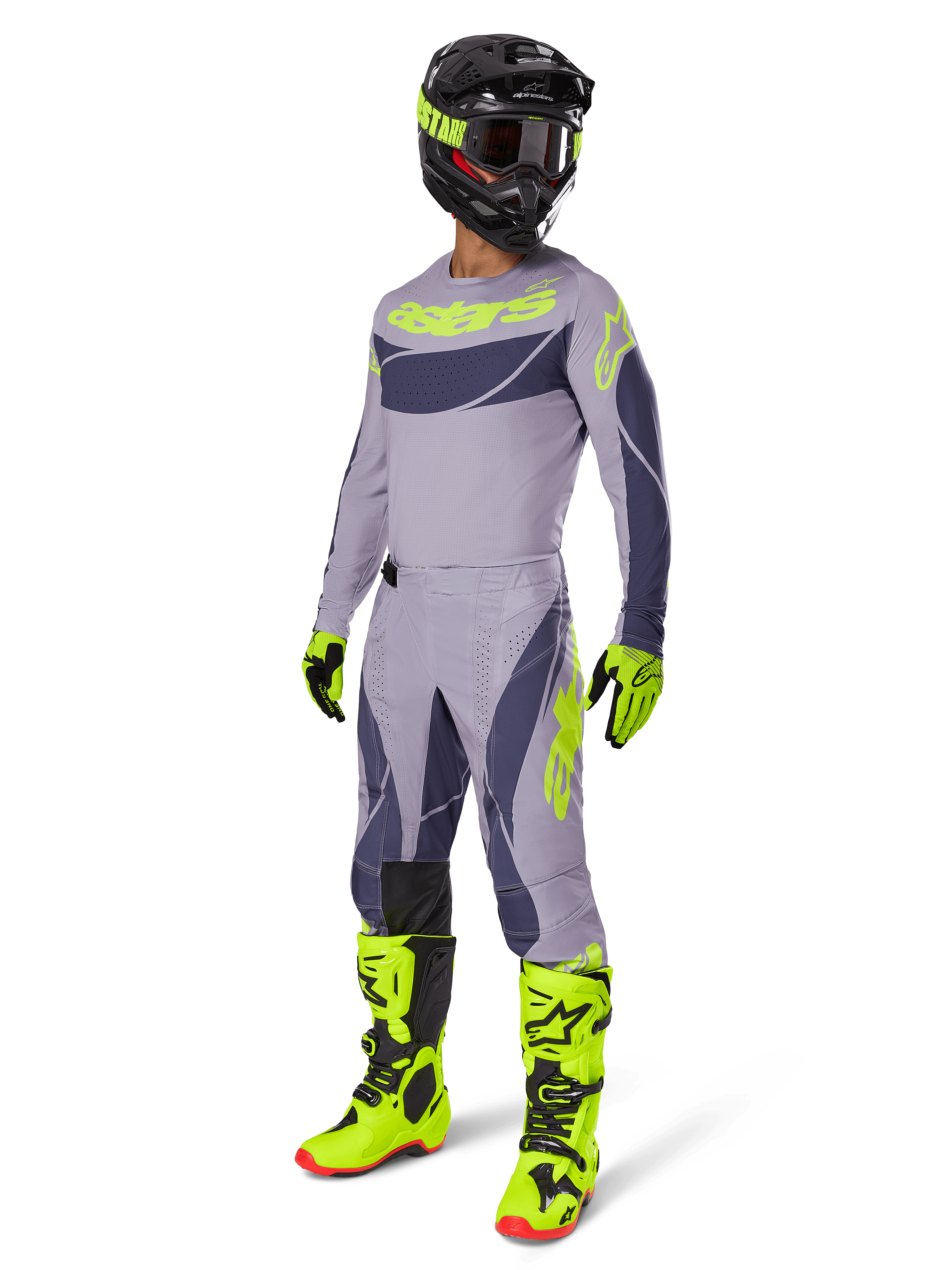 Motocross rider wearing the 2025 Techstar Dreem Jersey in gray and dark gray with neon yellow accents, complete racing gear set including matching gray pants, neon yellow boots and gloves, and a black helmet, coordinated off-road performance outfit