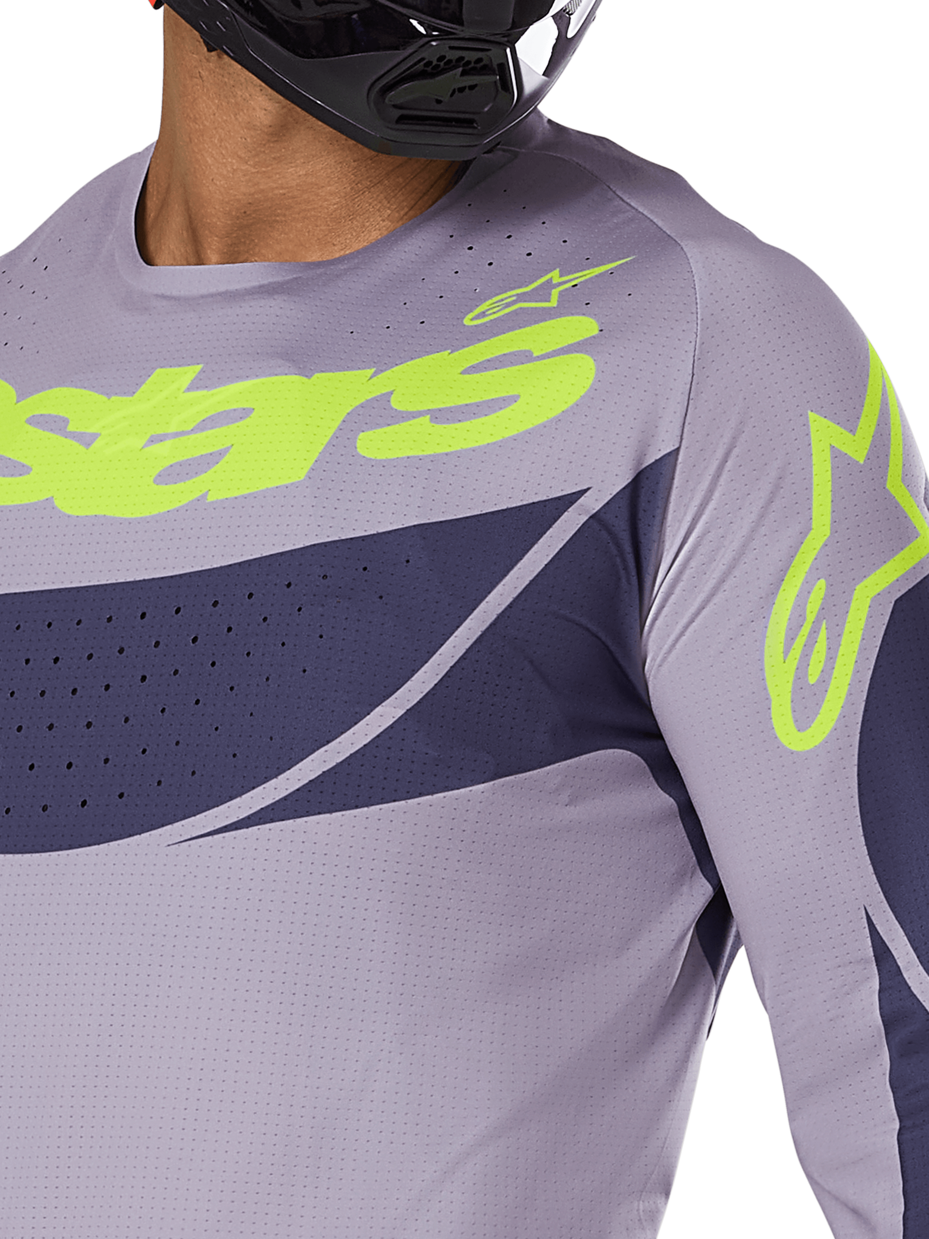 Alpinestars 2025 Techstar Dreem Jersey, camisola de motocross, cinzenta e azul-marinho com logótipo verde lima vibrante, grande plano de um piloto com capacete preto, apresentando perfurações cortadas a laser para ventilação