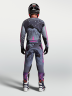 Alpinestars Calças Racer Lone, calças de motocross para homem, cinzentas camufladas e roxas, vista traseira, ajuste de corrida durável para off-road.