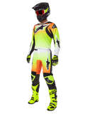 Alpinestars 2025 Fluid Wurx Gear Set, equipamento de motocross, degradé em amarelo néon e laranja, kit completo com camisola e calças, capacete preto com óculos laranja, botas e luvas em amarelo néon, design atlético para performance off-road