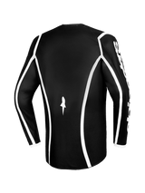 Alpinestars 2026 Fluid Apex Jersey, Motocross Jersey, Black with white curved piping, back view showing ergonomic cut and small white logo, performance long-sleeve jersey for off-road racing