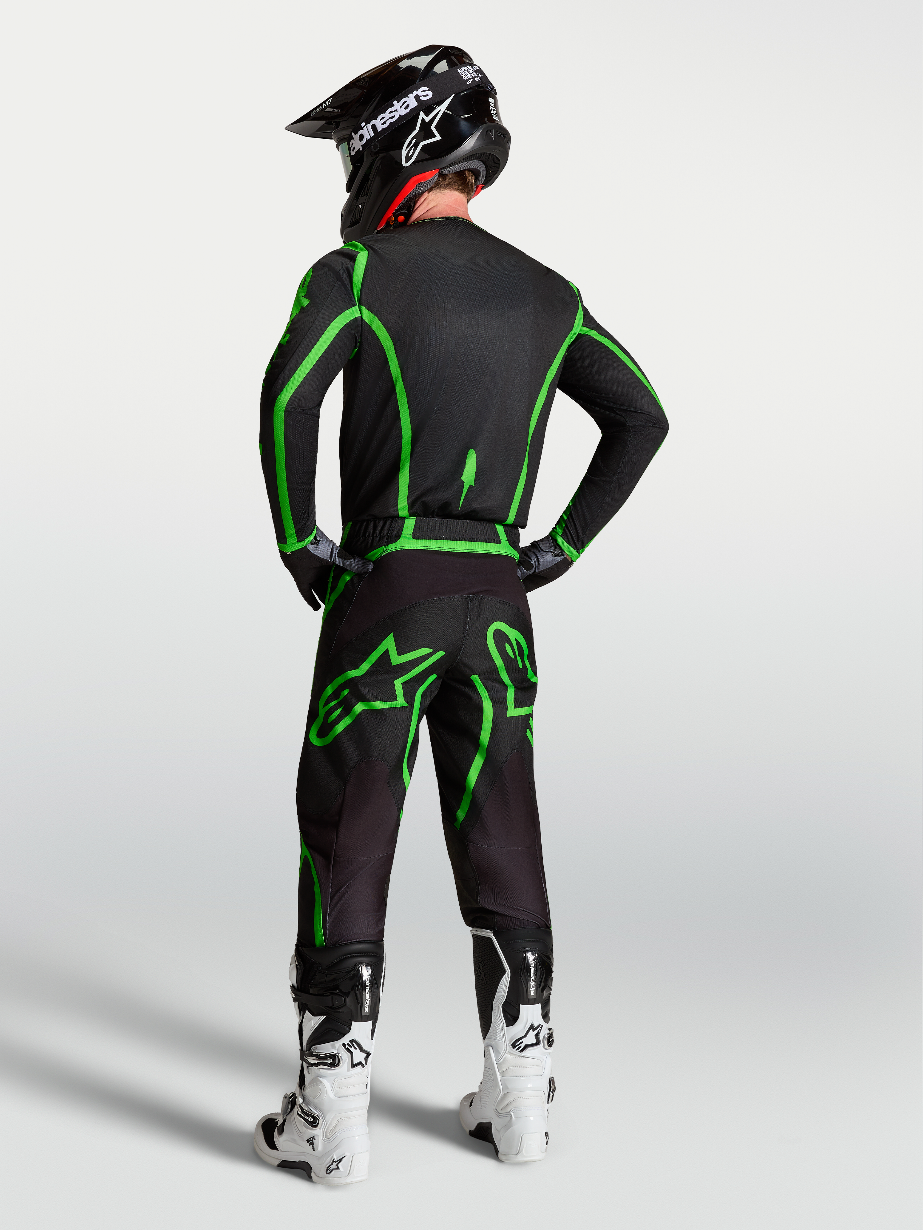 Alpinestars Camisola Fluid Apex V2, camisola de motocross para homem, preta e verde fluo, vista traseira no modelo com calças