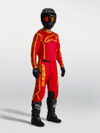 Alpinestars Camisola Fluid Apex V2, camisola de motocross para homem, vermelha e dourada, em polifibra respirável com absorção de humidade, ideal para off-road.