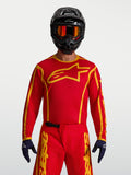 Alpinestars Camisola Fluid Apex V2, camisola de motocross para homem, vermelha e dourada, em tecido leve e respirável.