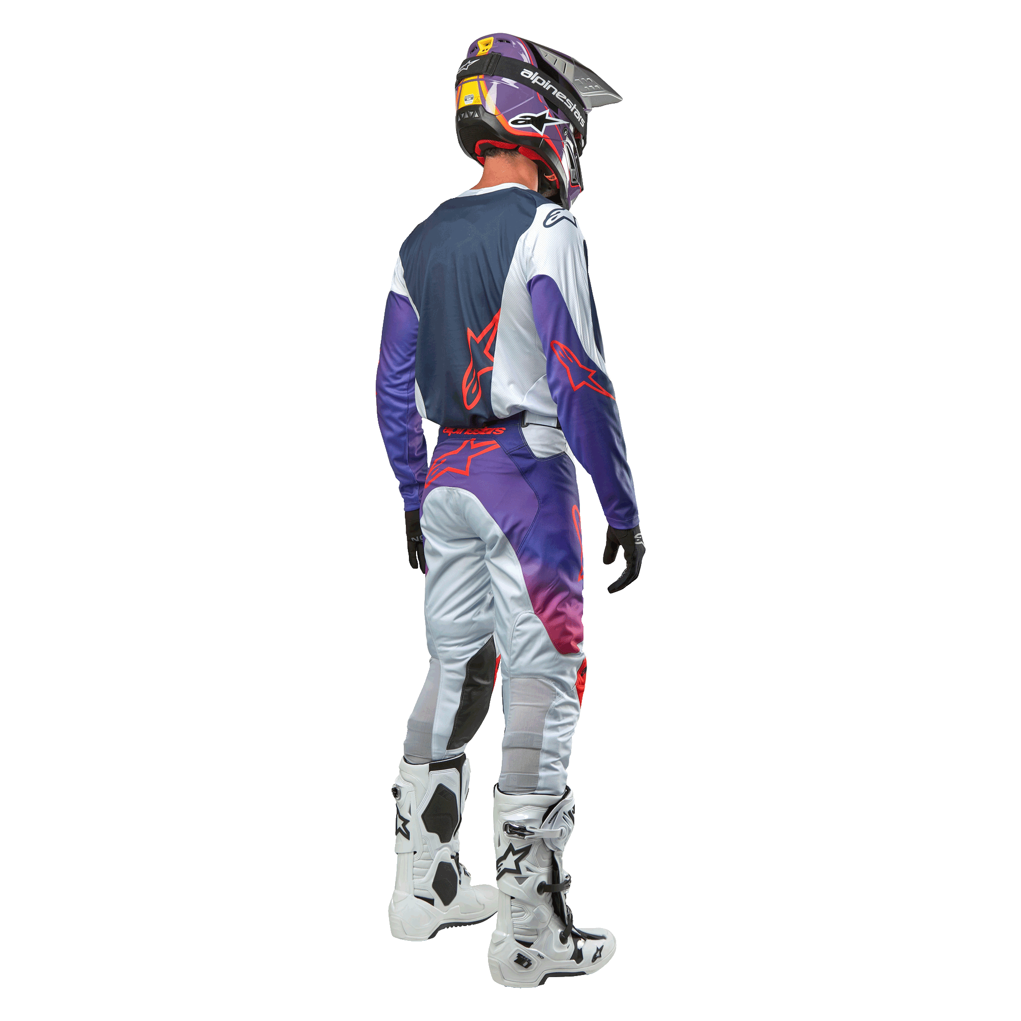 Motocross rider seen from behind wearing the Alpinestars 2024 Racer Hoen Jersey in Light Gray Hot Orange Black, navy back panel with orange star logo, purple sleeves, worn with matching racing pants and white boots.