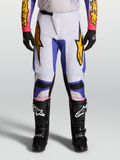 Alpinestars Fluid Drag 2027, calças de motocross para homem em lilás claro e azul com pormenores dourados.