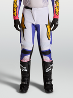 Alpinestars Fluid Drag 2027, calças de motocross para homem em lilás claro e azul com pormenores dourados.