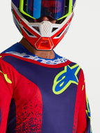 Alpinestars Fluid Drag, camisola de motocross azul marinho e vermelha para homem, com logótipo no peito e gola desportiva.