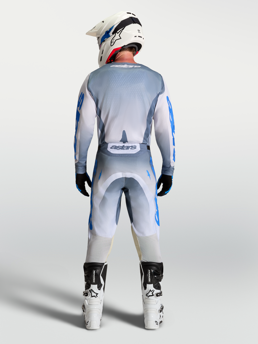 Alpinestars Racer Amber, conjunto de calças e camisola de motocross para homem, cinzento e azul, vista traseira.