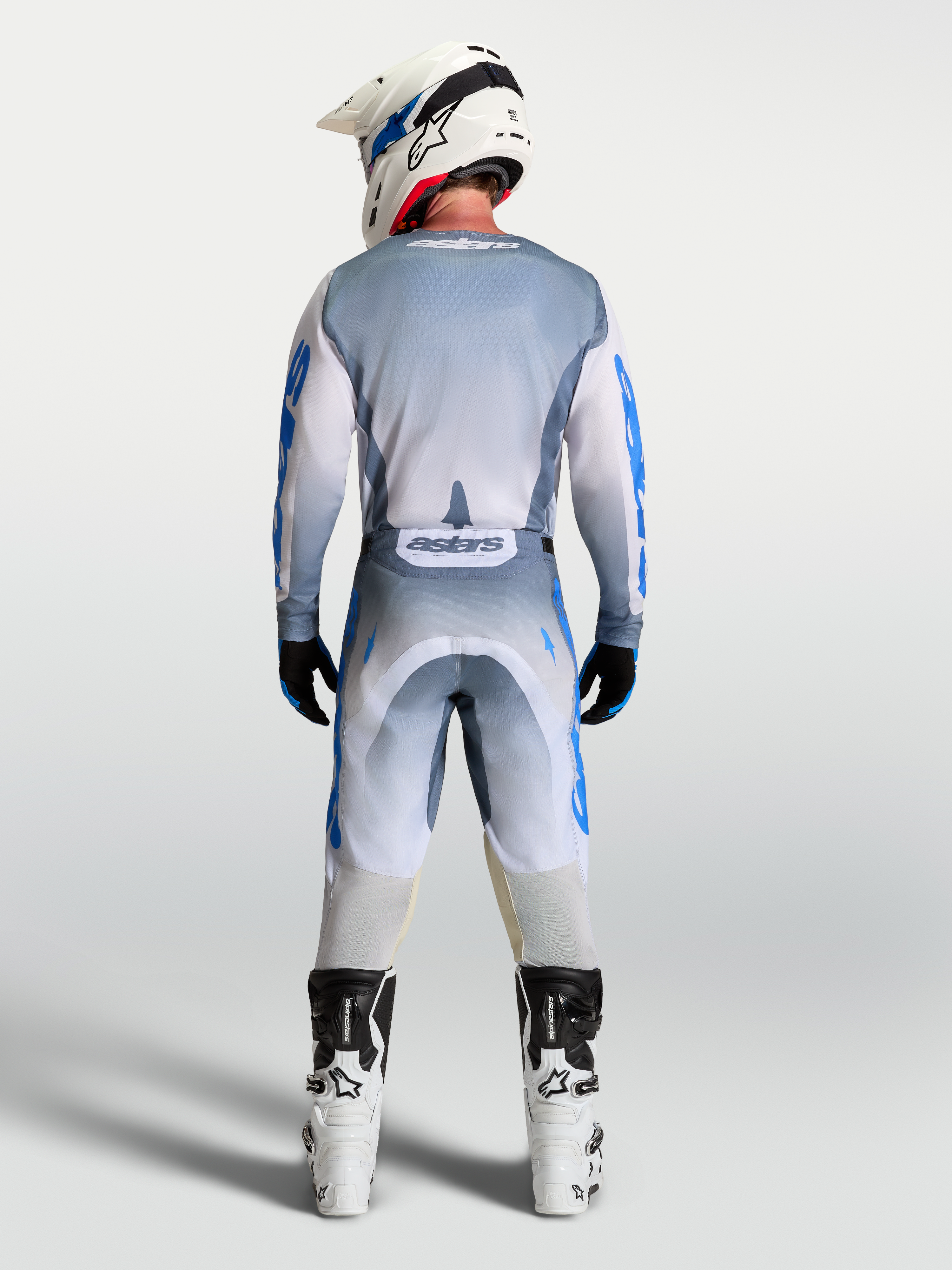 Alpinestars Racer Amber, conjunto de calças e camisola de motocross para homem, cinzento e azul, vista traseira.