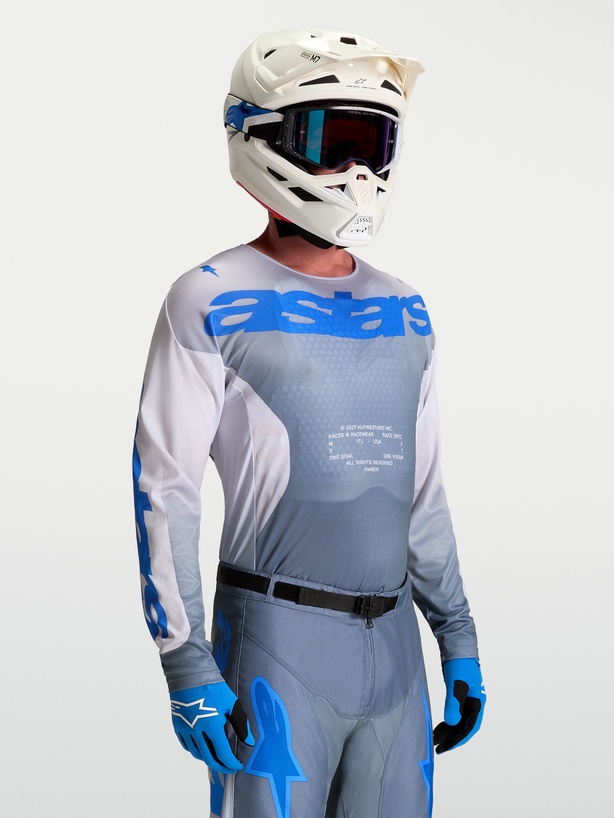 Alpinestars 2027 Racer Amber Jersey, Men's Ash Gray and UCLA Blue Motocross Jersey on-model with matching gear.