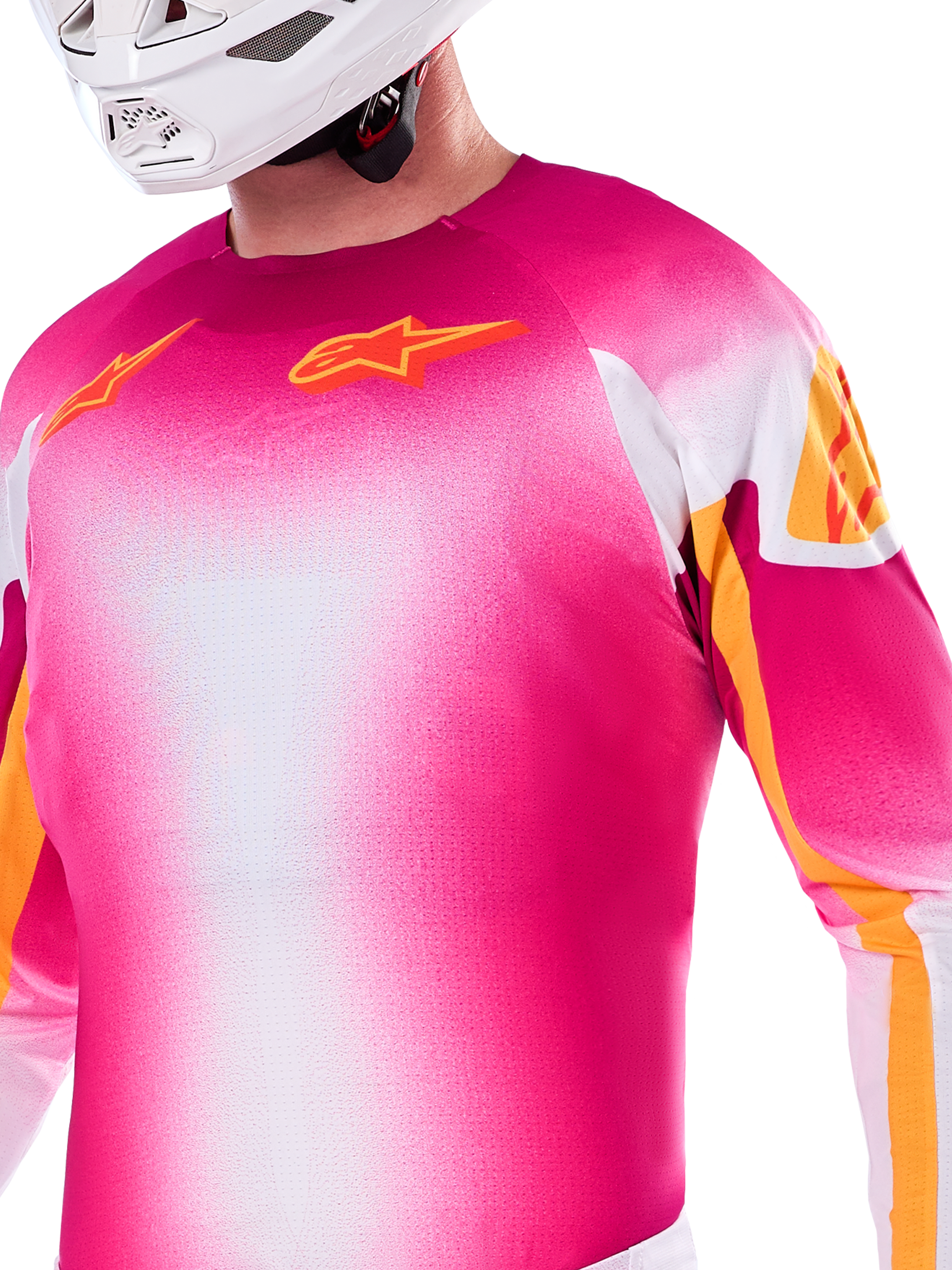 Alpinestars Limited Edition Supertech AFD MIG Jersey, Motocross Jersey in Pink Fluo and White gradient, featuring orange Astars logos and sleeve accents, worn by a rider with a white helmet, athletic racing fit.