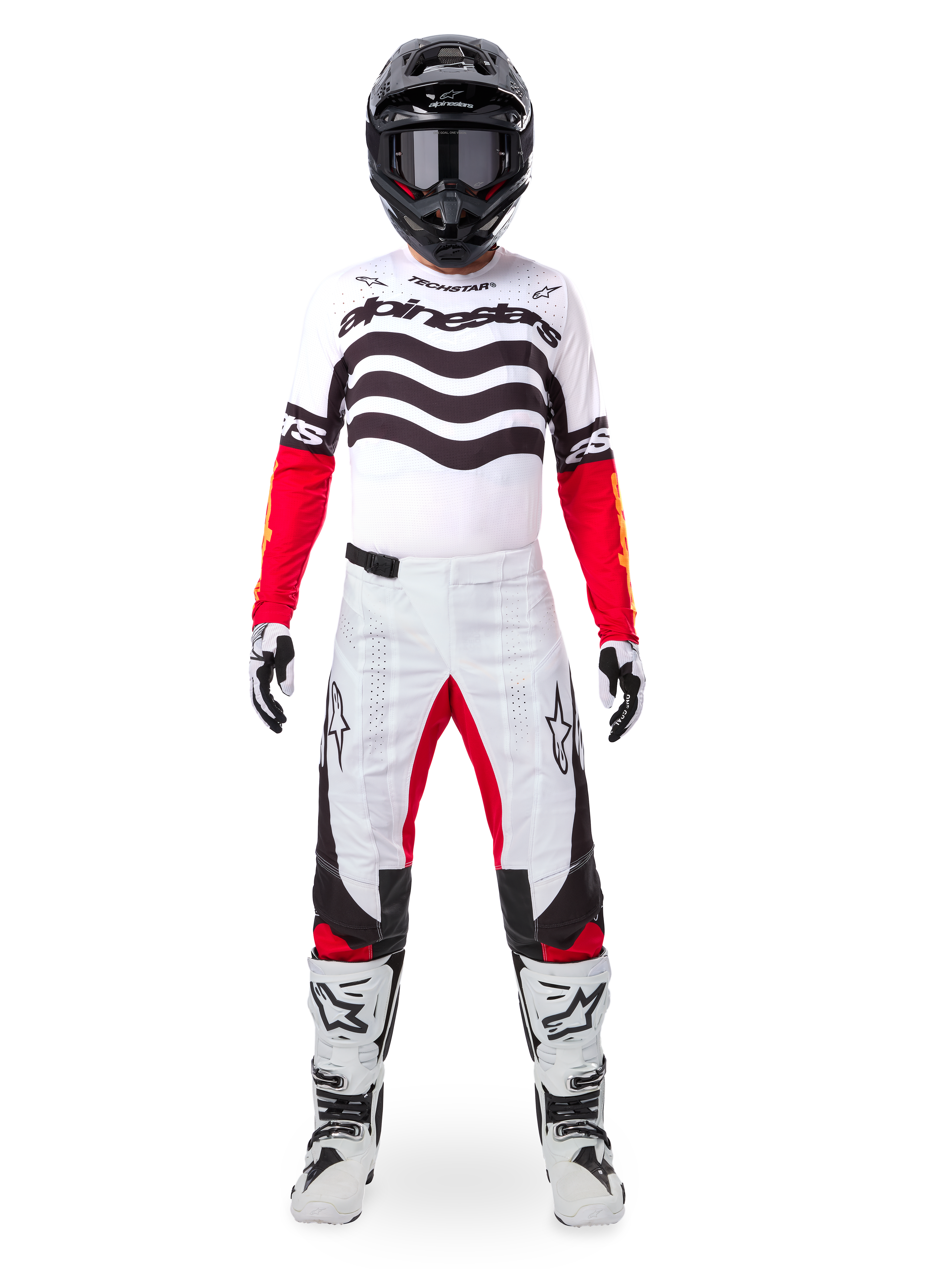 Motocross rider wearing the Alpinestars Limited Edition Techstar Deep Jersey in white, black, and red, featuring wavy chest graphics, paired with matching white and red pants, a black helmet, and white racing boots, full professional off-road gear setup.
