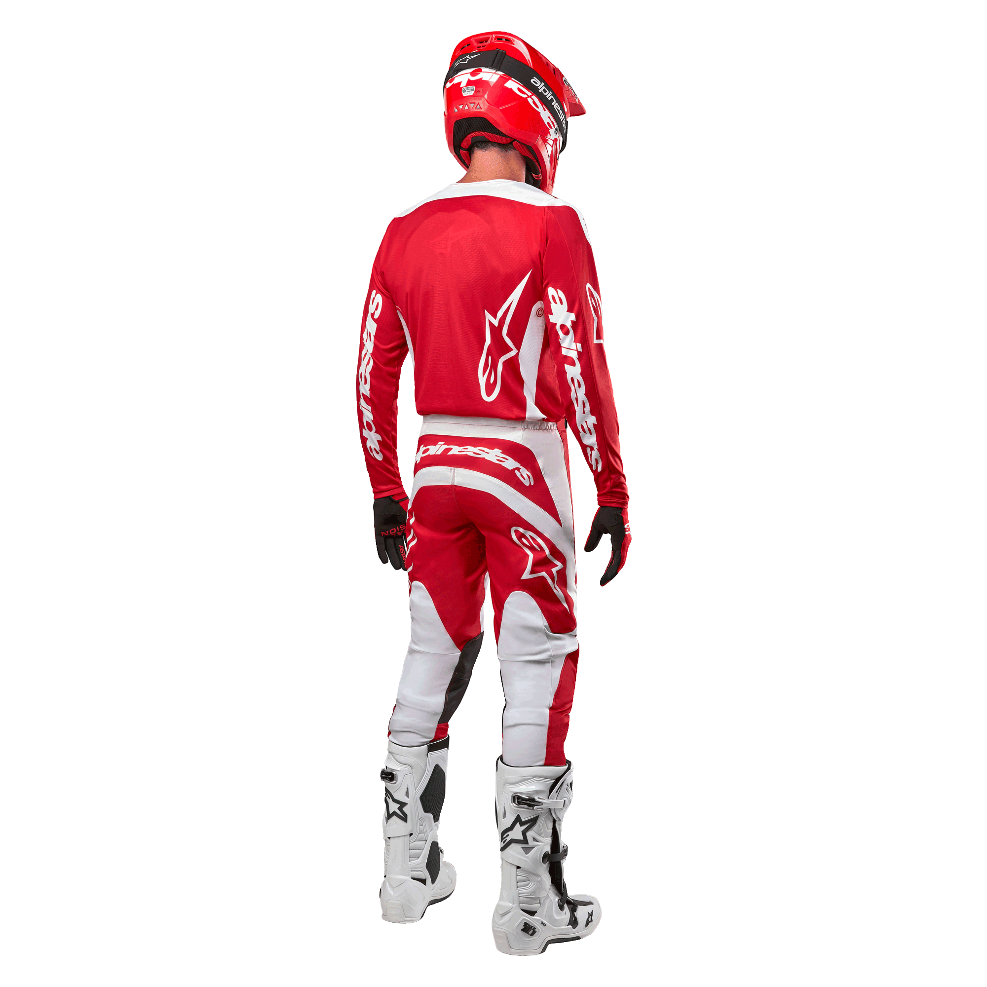 Vista traseira de um piloto de motocross a usar a Camisola Alpinestars 2024 Fluid Lurv em Vermelho Mars e Branco, combinada com calças vermelhas e brancas a condizer, botas de todo-o-terreno brancas e um capacete vermelho, mostrando o design das costas da camisola e o logótipo Alpinestars.