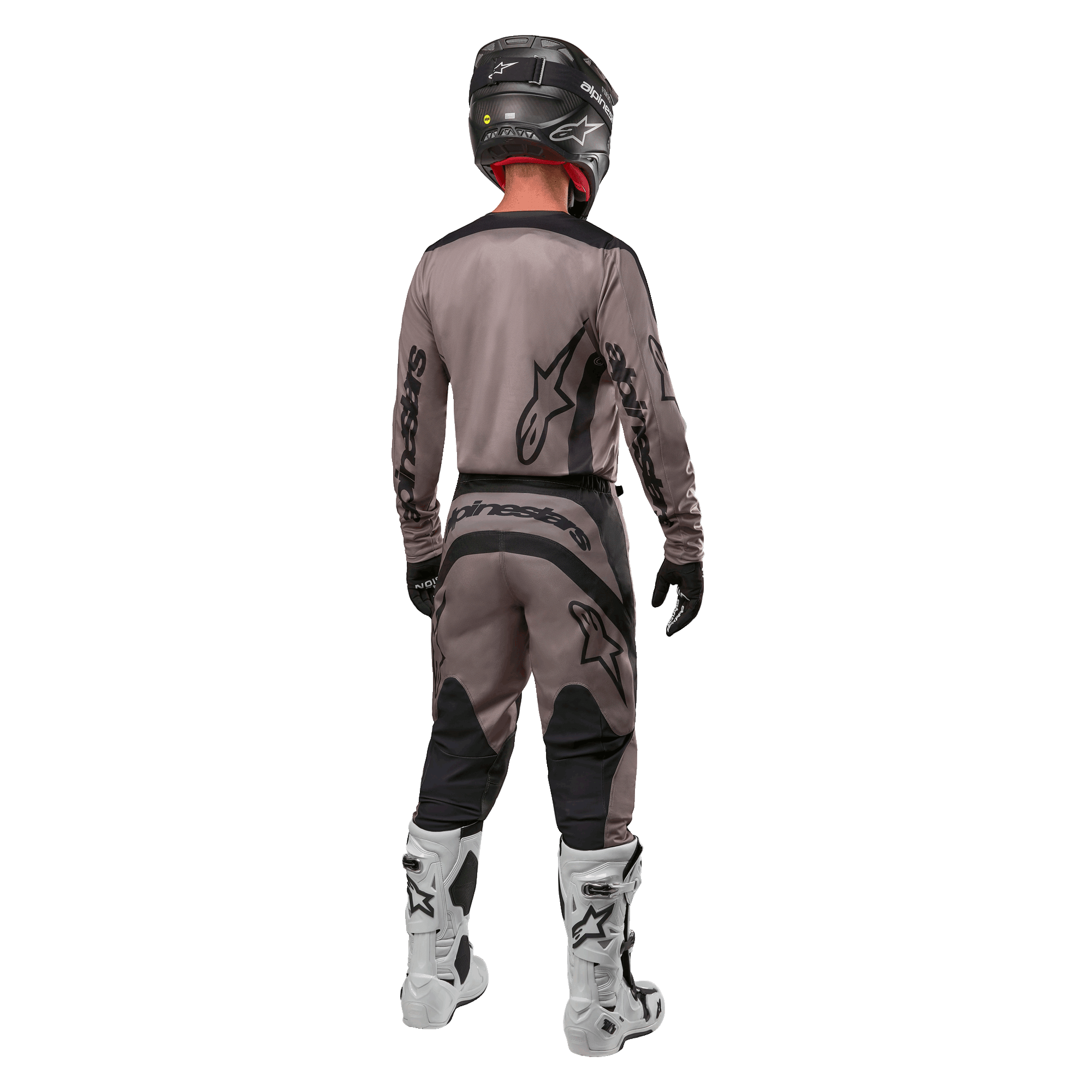 Alpinestars 2024 Fluid Lurv Jersey, Motocross Jersey, Mud Black, rear view of motocross rider wearing matching racing gear, black helmet, and white boots, featuring bold black Alpinestars logos and an athletic fit for off-road performance.
