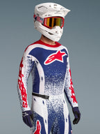 Alpinestars Techstar Unity Jersey edição limitada, camisola de motocross para homem, design de salpicos vermelho e azul, modelo vestido.