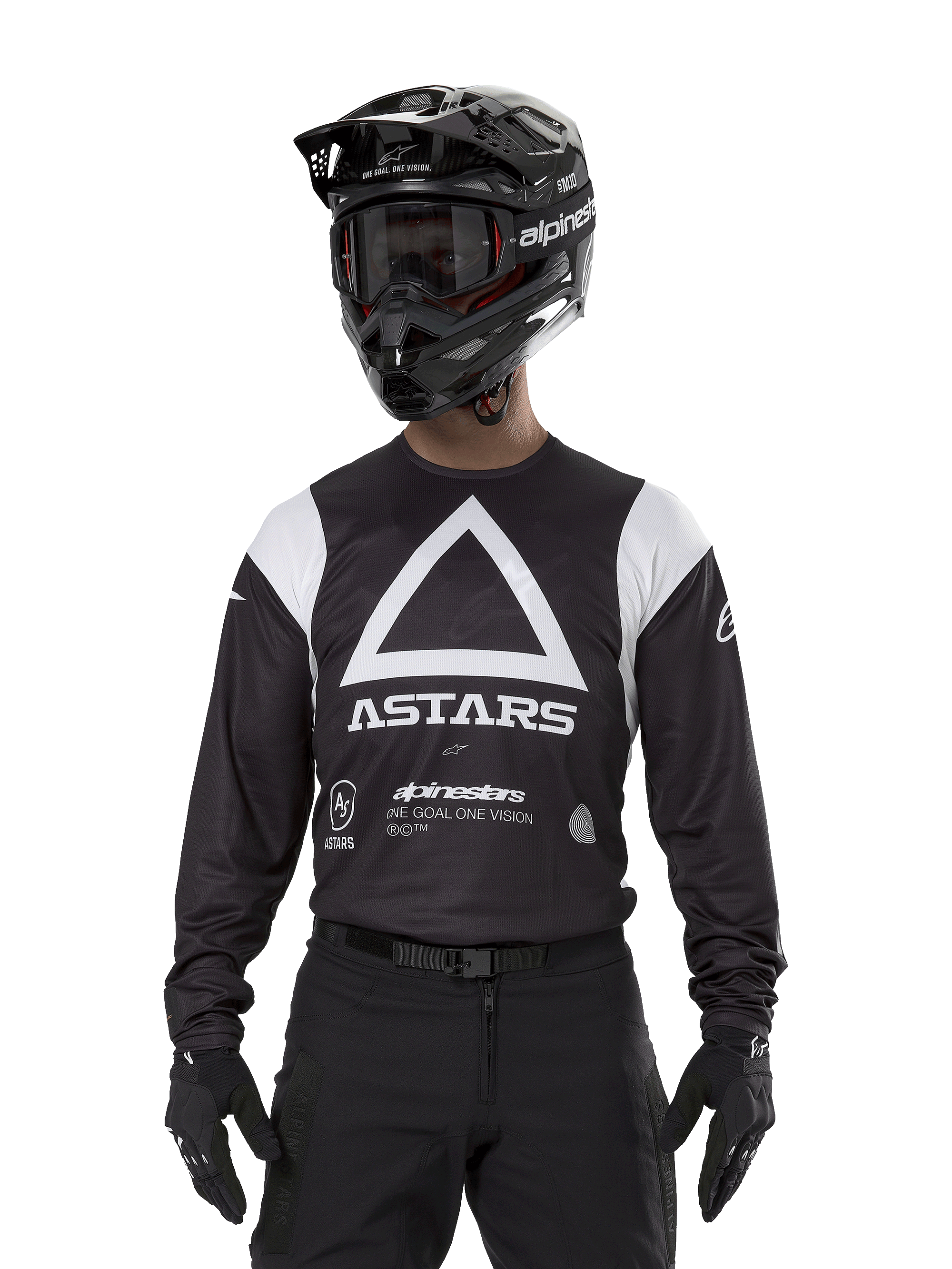 Alpinestars Techdura Jersey, Black, featuring a large white triangle chest graphic with ASTARS logo and white shoulder panels, worn by a rider with a black motocross helmet, goggles, and matching black off-road gear.