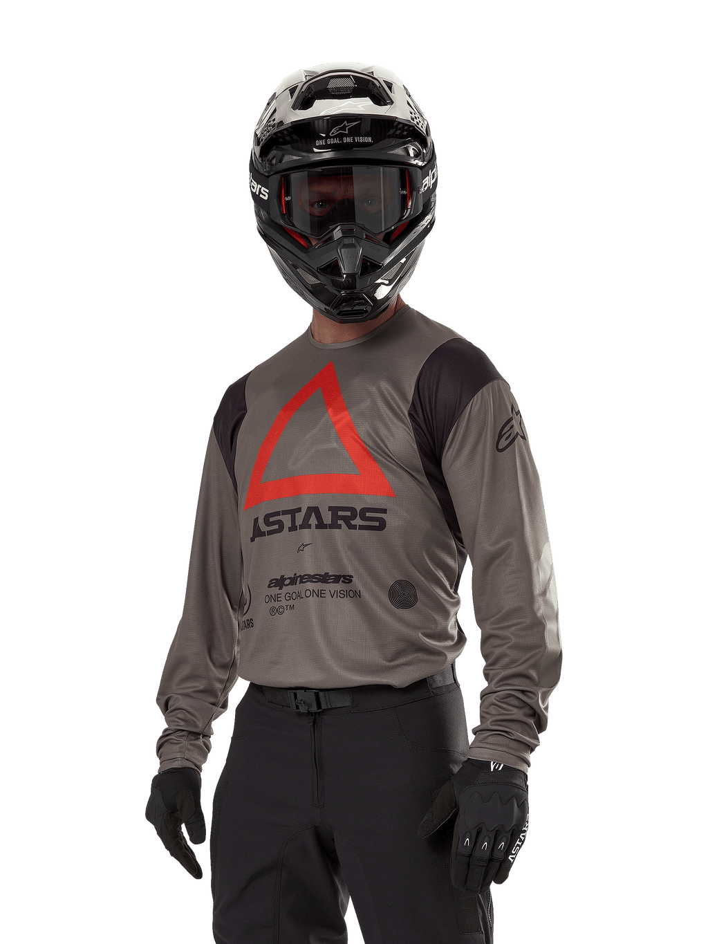 Alpinestars Techdura Jersey, camisola de motocross e todo-o-terreno, castanho Falcon com triângulo vermelho e logótipos pretos, usada com calças pretas, capacete preto e branco e luvas pretas