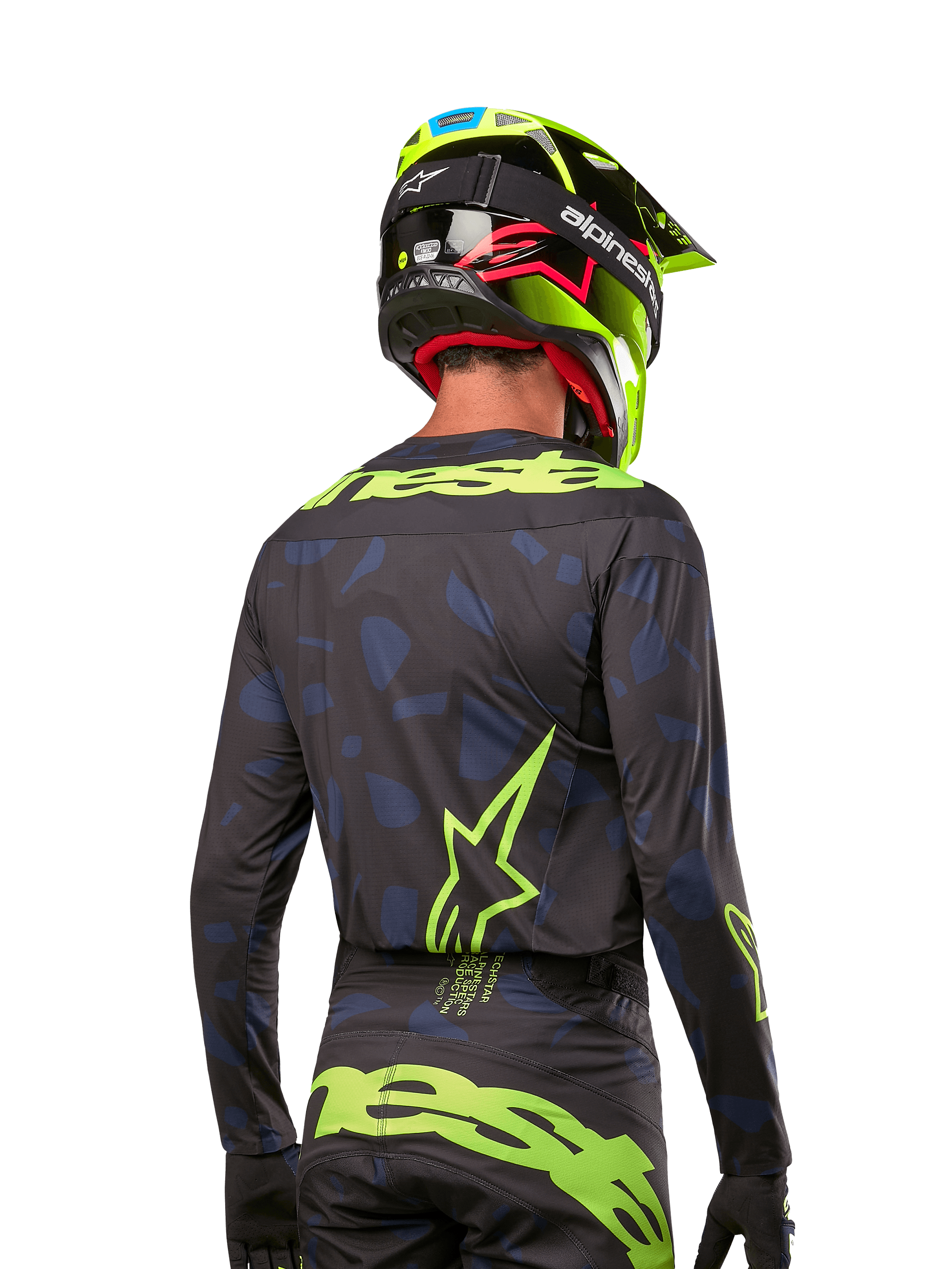 Rear view of a motocross rider wearing the Alpinestars 2024 Techstar Rantera Jersey in Black Navy Yellow Fluo, featuring prominent yellow fluo branding and logos on the back, paired with matching motocross pants and a neon yellow helmet for a complete off-road racing look.