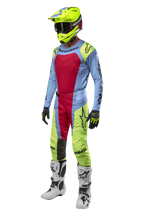 Alpinestars 2024 Techstar Ocuri Jersey and gear set, Motocross rider in Light Blue, Yellow Fluo, and Red Berry kit, including a fluo yellow helmet, matching pants, and white boots, coordinated racing outfit for off-road competition