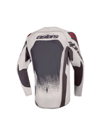 Alpinestars Camisola Supertech Swan Jovem, camisola de motocross para jovens, cinzenta e cinzento escuro, vista traseira com malha ventilada e pormenores vermelhos.
