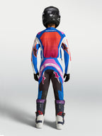 Alpinestars Juventude Supertech Maven Gear Set, camisola e calças de motocross azuis e coral, vista traseira no modelo.