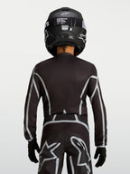 Camisola Alpinestars Fluid Apex V2 Jovem, camisola de motocross preta e prateada, vista traseira com ajuste ergonómico e cobertura traseira estendida