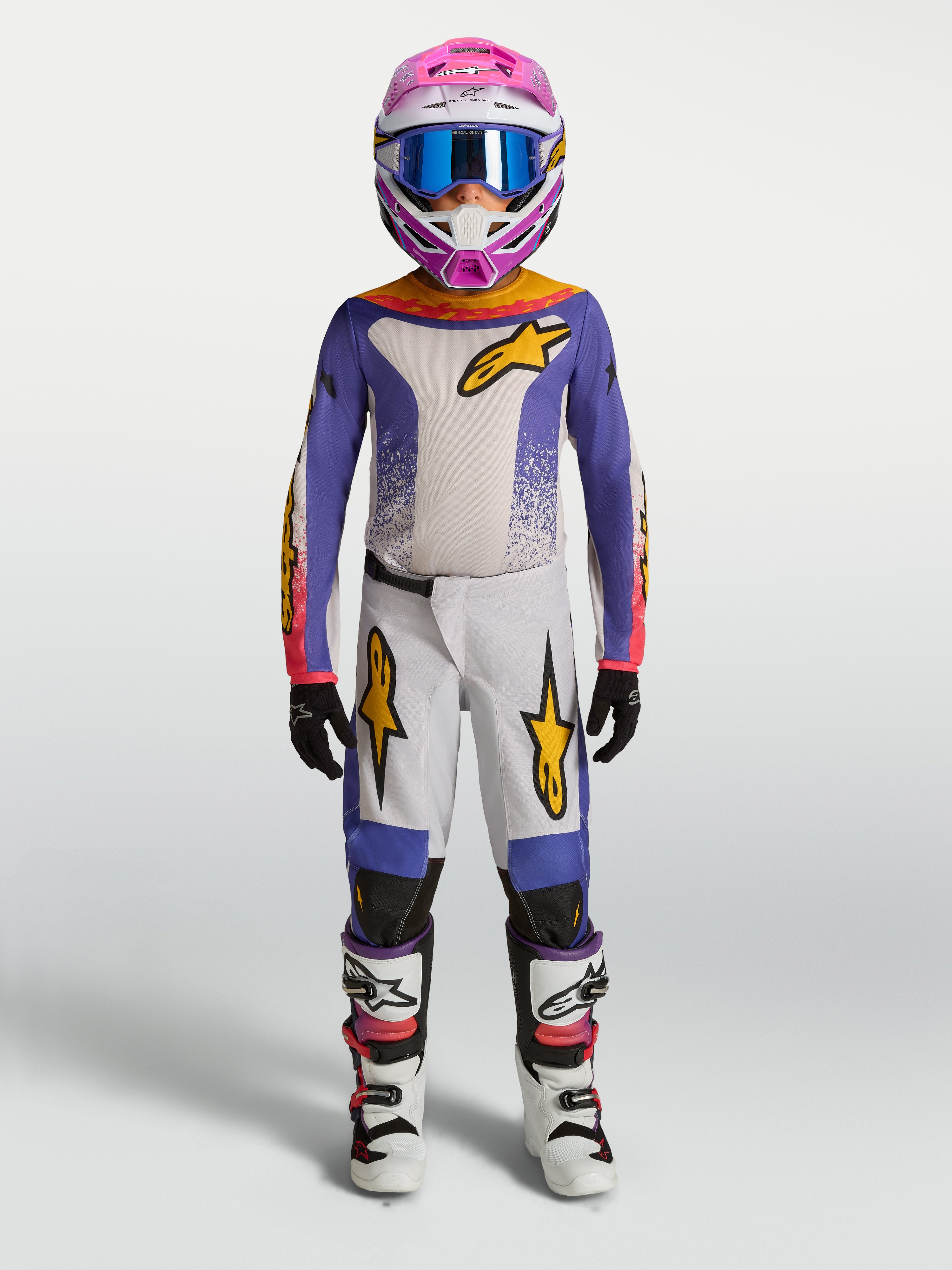 Alpinestars camisola e gear set Fluid Drag juventude 2027, conjunto de motocross para jovens em lilás e branco com pormenores dourados, ajuste ergonómico off-road.