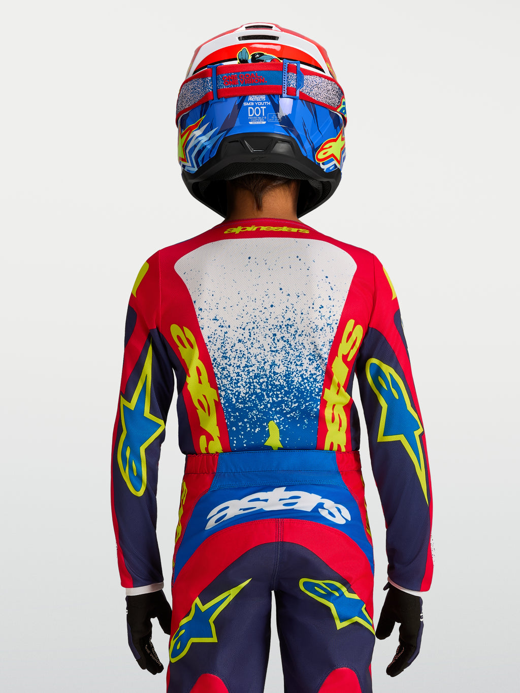 Alpinestars Camisola Fluid Drag Jovem 2027, camisola de motocross e todo-o-terreno para jovens, azul e vermelha, vista traseira de piloto com ajuste ergonómico.